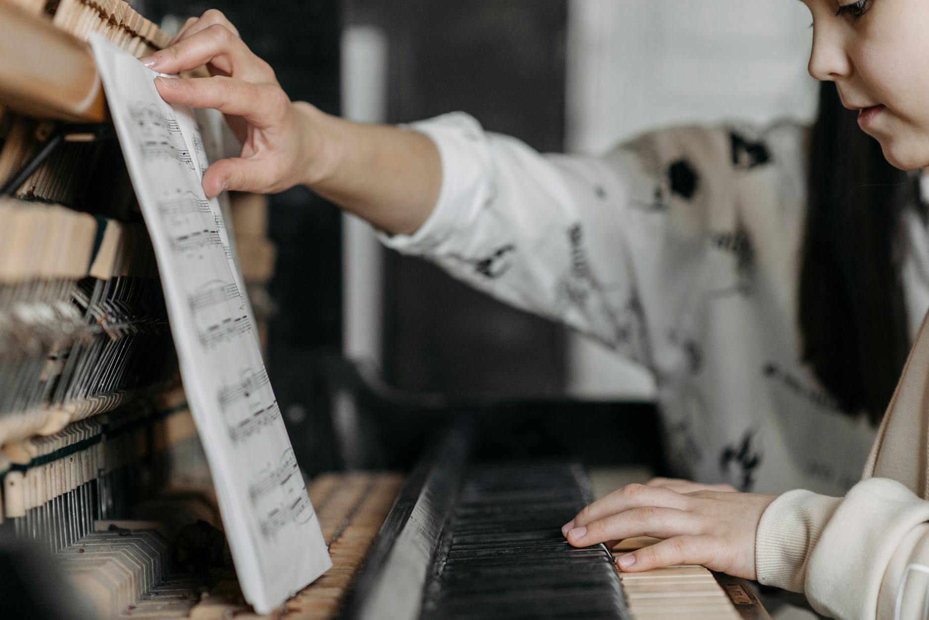 Child learning piano with sheet music at Melodious Piano Studio